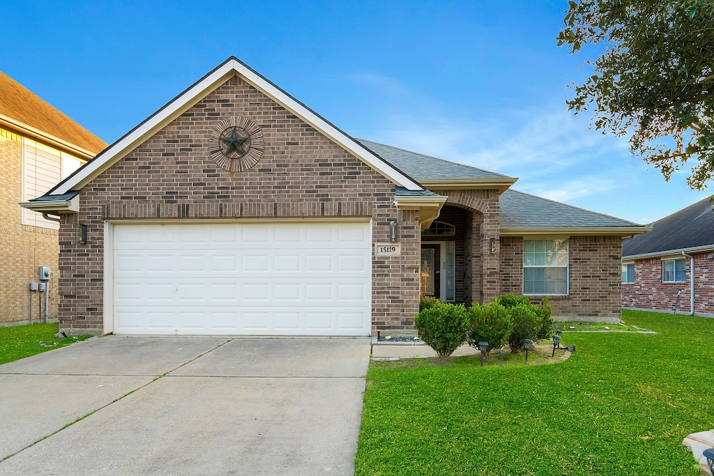 ranch-style home with a garage and a front yard