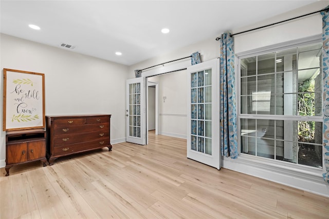 interior space with french doors and light hardwood / wood-style floors