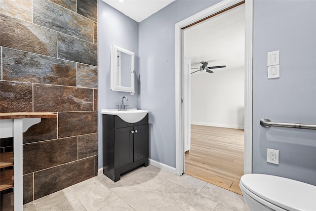 bathroom featuring vanity, ceiling fan, and toilet