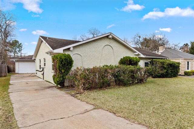 view of home's exterior with a garage and a lawn