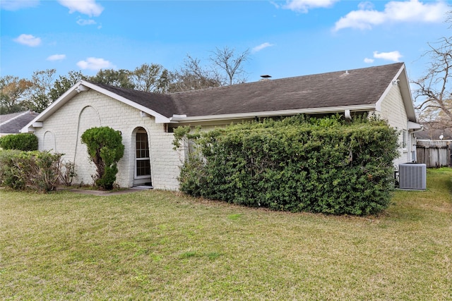 single story home featuring a front yard and central air condition unit