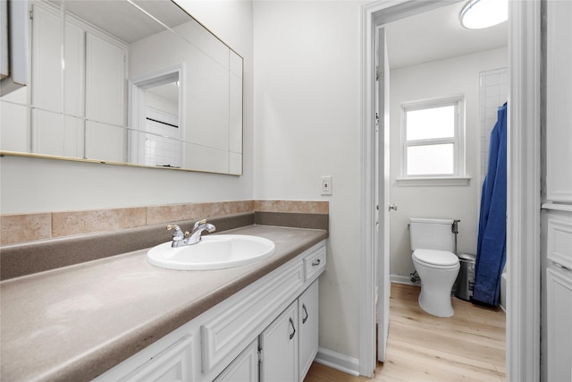 full bathroom with vanity, wood-type flooring, shower / bath combination with curtain, and toilet