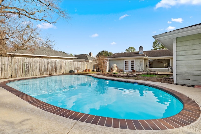 view of pool featuring french doors