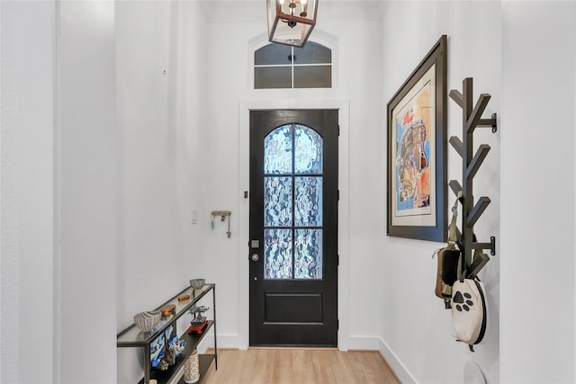 entrance foyer with crown molding and light wood-type flooring