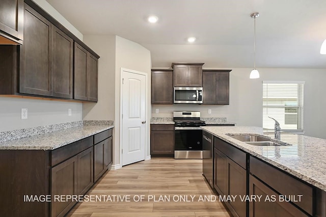 kitchen featuring decorative light fixtures, sink, light hardwood / wood-style floors, stainless steel appliances, and dark brown cabinets