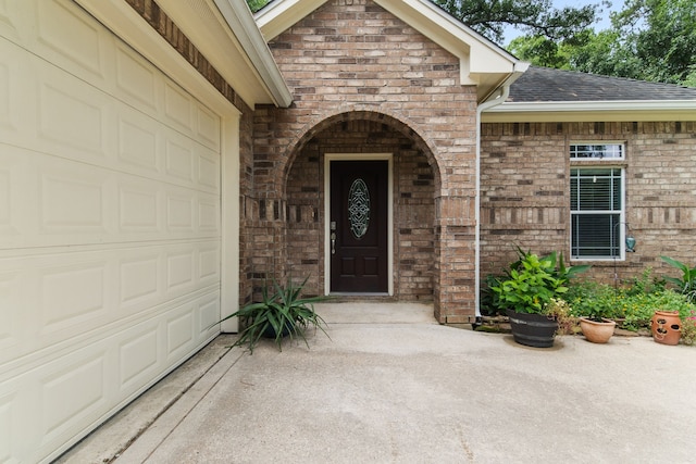 view of exterior entry featuring a garage