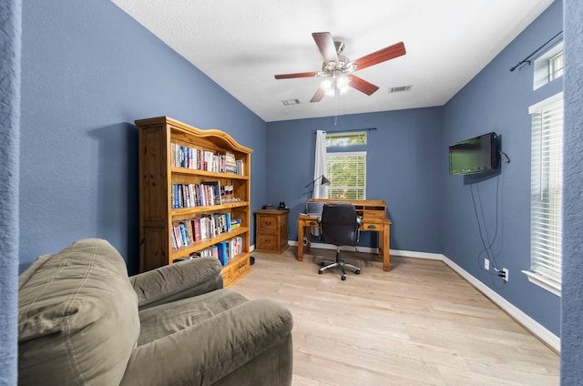 office area with ceiling fan and light hardwood / wood-style floors