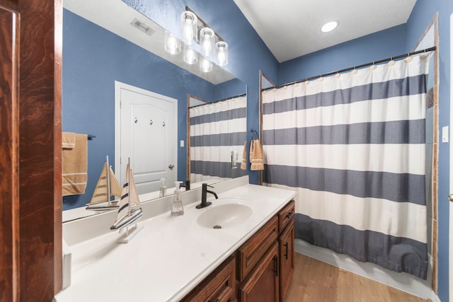 bathroom featuring vanity, a shower with shower curtain, and wood-type flooring