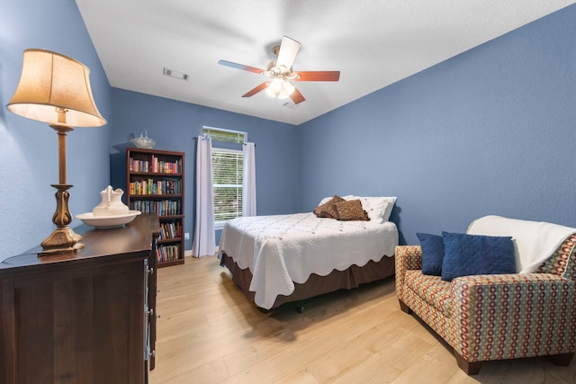 bedroom featuring ceiling fan and light hardwood / wood-style flooring