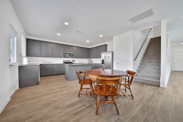 dining space with sink and light hardwood / wood-style flooring