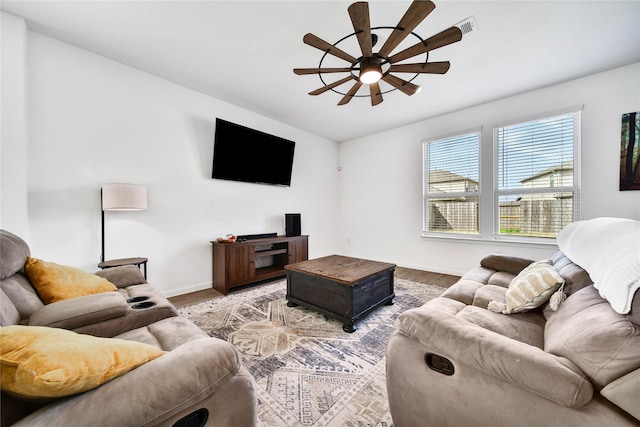 living room featuring ceiling fan and light hardwood / wood-style floors