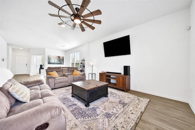 living room with wood-type flooring and ceiling fan