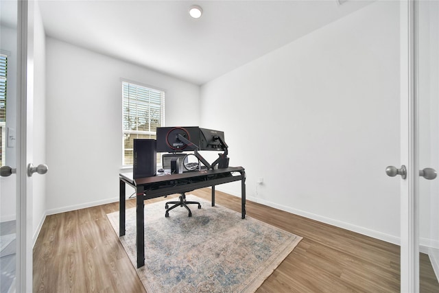 office space with french doors and hardwood / wood-style floors