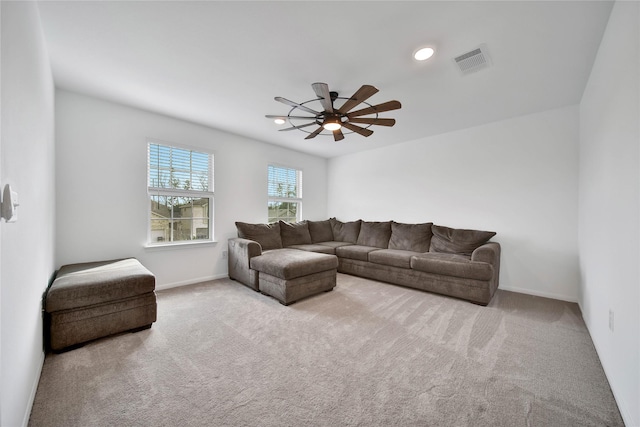 carpeted living room with ceiling fan