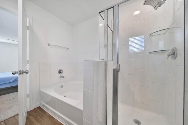 bathroom featuring independent shower and bath and hardwood / wood-style floors