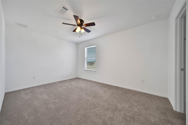 carpeted spare room with ceiling fan