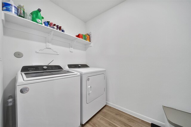 washroom featuring wood-type flooring and washer and clothes dryer