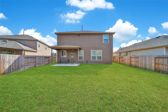 back of house with a yard and a patio