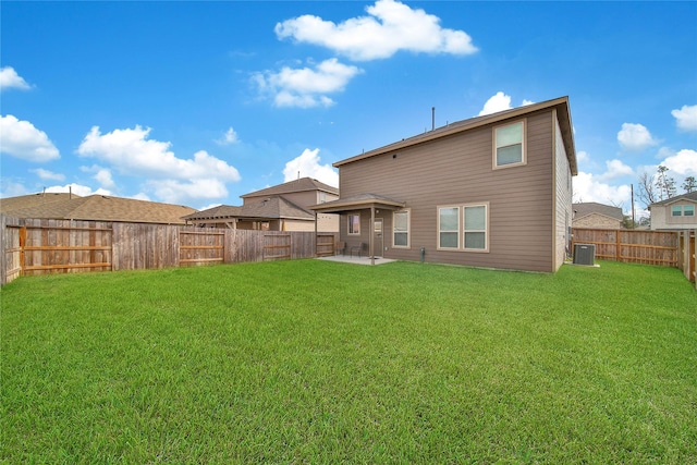 back of house with central AC, a patio area, and a lawn