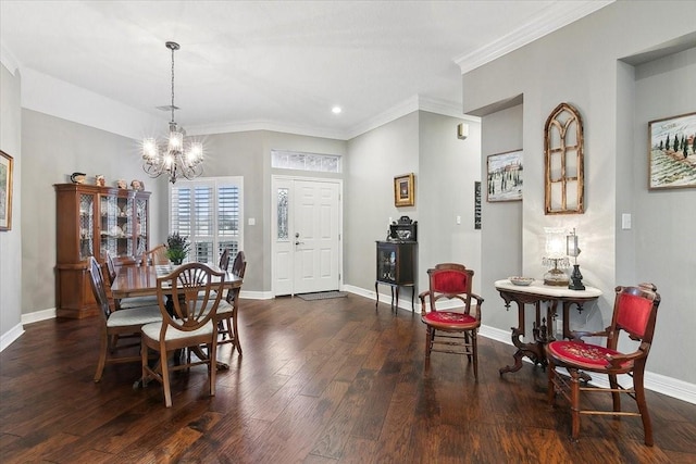 dining space featuring dark hardwood / wood-style flooring, ornamental molding, and an inviting chandelier