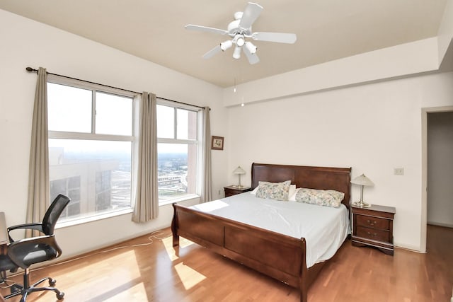 bedroom with ceiling fan and light hardwood / wood-style flooring