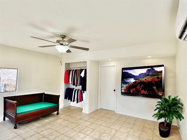 sitting room featuring a ceiling fan, baseboards, and a wall mounted AC