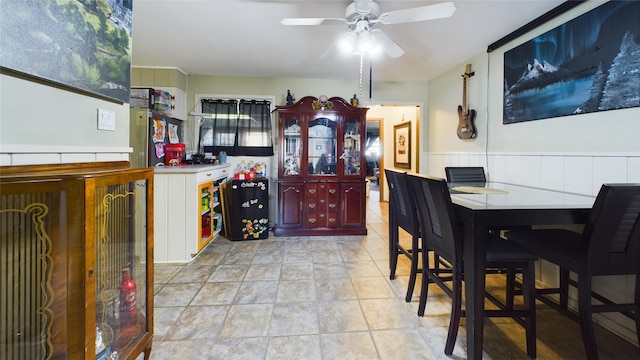 tiled dining area featuring ceiling fan