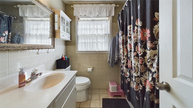 bathroom with tile patterned flooring, vanity, plenty of natural light, and toilet