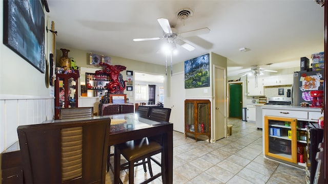 dining space featuring light tile patterned floors and ceiling fan