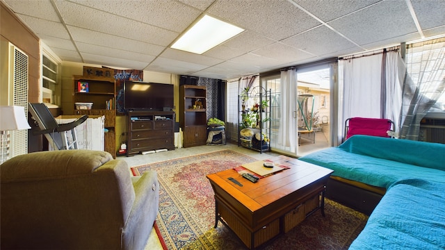 living room featuring a drop ceiling