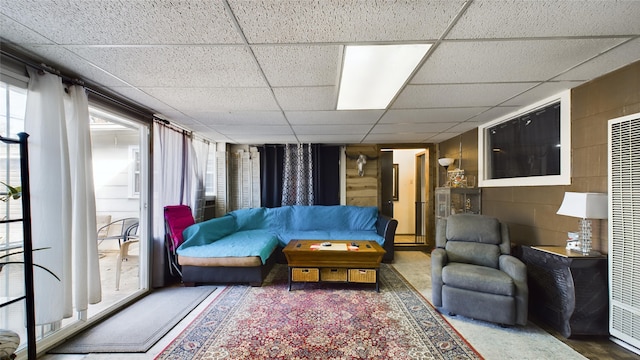 living room with a drop ceiling