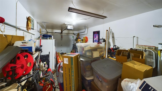 garage with a garage door opener and white fridge