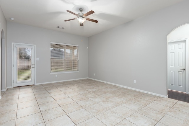 spare room with ceiling fan and light tile patterned floors