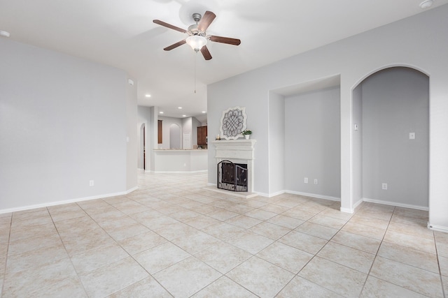 unfurnished living room featuring light tile patterned flooring and ceiling fan