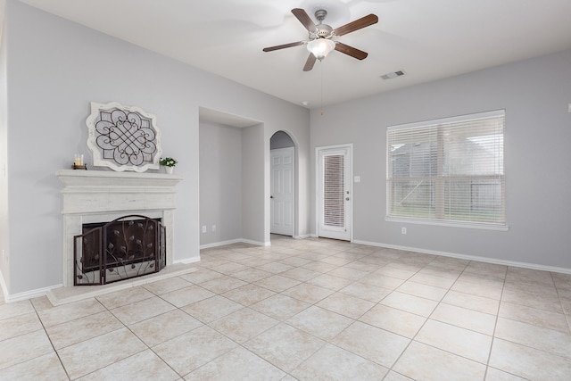 unfurnished living room with ceiling fan and light tile patterned flooring