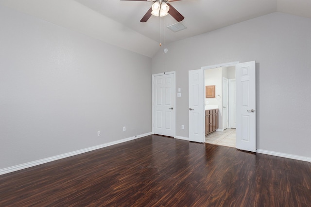 unfurnished bedroom with hardwood / wood-style floors, ensuite bath, vaulted ceiling, and ceiling fan