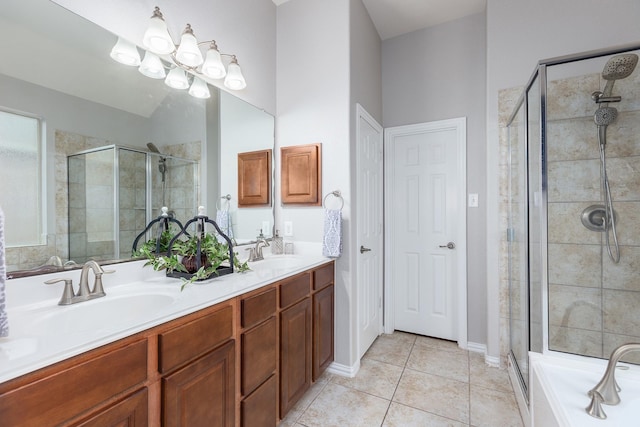 bathroom featuring shower with separate bathtub, tile patterned floors, and vanity