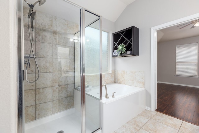 bathroom featuring a healthy amount of sunlight, lofted ceiling, shower with separate bathtub, and tile patterned flooring