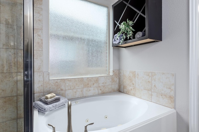 bathroom with a tub to relax in