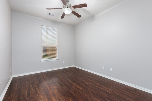 spare room featuring ceiling fan and dark hardwood / wood-style floors