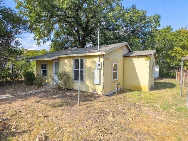 back of house with a yard