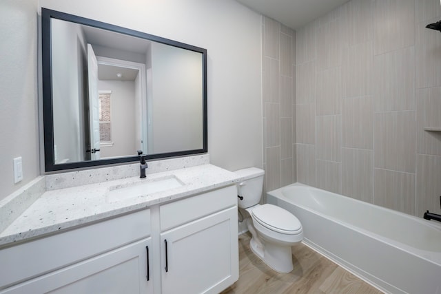 full bathroom with vanity, toilet, tiled shower / bath combo, and wood-type flooring