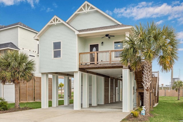 view of front of home with ceiling fan, a carport, and a balcony