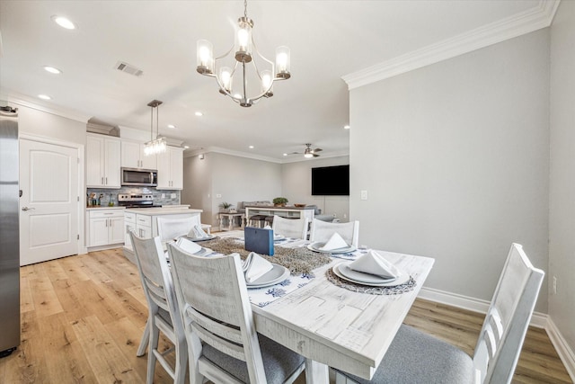 dining space with ornamental molding, ceiling fan with notable chandelier, and light hardwood / wood-style flooring