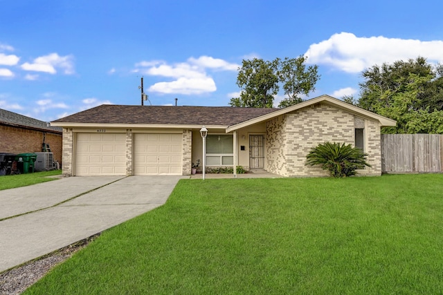 single story home with a garage and a front lawn