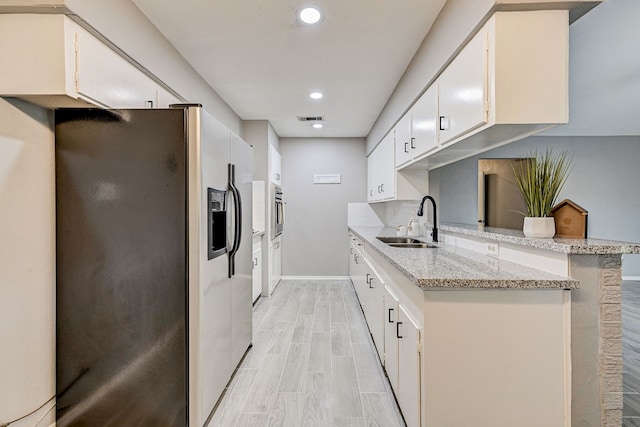 kitchen featuring white cabinetry and appliances with stainless steel finishes