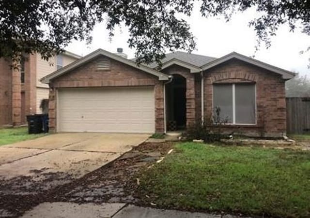 ranch-style house with a garage and a front lawn