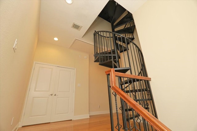 stairs featuring hardwood / wood-style flooring