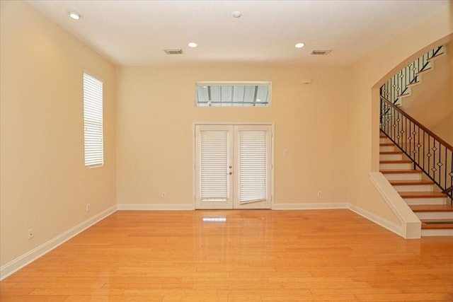 interior space with light hardwood / wood-style flooring and french doors