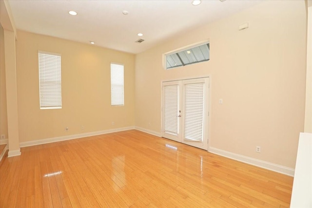 unfurnished bedroom with french doors and light wood-type flooring